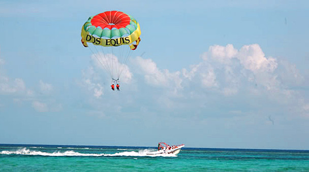 a parachute is tied to the boat showing you cristal waters